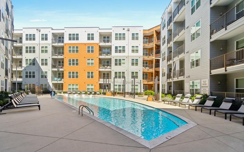 a pool in a courtyard between buildings